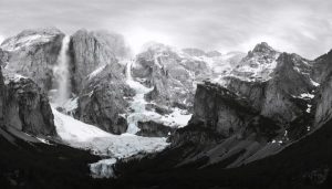 Montage of iconic black-and-white photographs showcasing Yosemite landscapes, melting glaciers, and polar regions, highlighting the work and influence of famous environmental photographers.