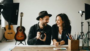 A photographer and their portrait subject sharing a moment of connection in a studio, highlighting trust and collaboration in ethical photography practices.