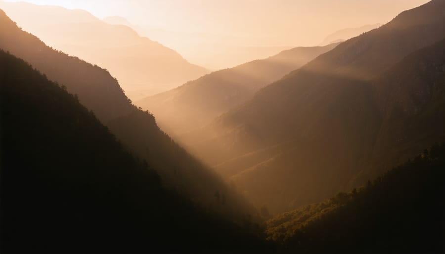 Mountain landscape bathed in warm golden hour light with dramatic shadows