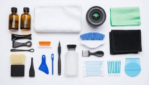 A professional lens cleaning kit neatly arranged on a table, comprising cleaning solutions, microfiber cloths, a lens pen, an air blower, and cotton swabs, illustrating the elements of a comprehensive lens cleaning system.