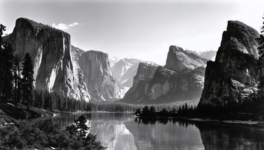 Classic Ansel Adams black and white photograph showing Yosemite Valley with dramatic clouds and tonal range